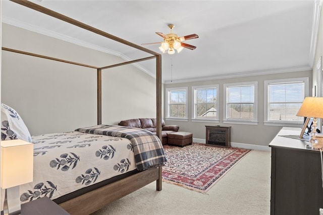 carpeted bedroom with ornamental molding and ceiling fan