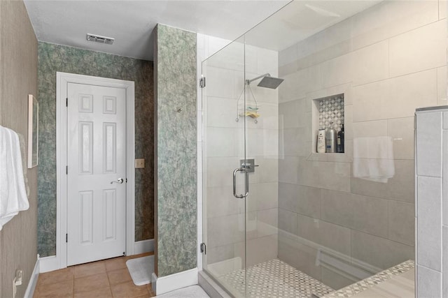 bathroom featuring tile patterned flooring and an enclosed shower