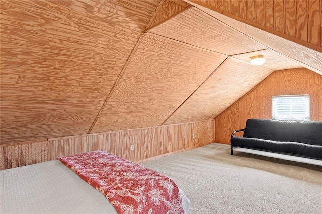 carpeted bedroom with lofted ceiling and wooden walls