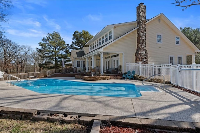 view of pool featuring a patio area and a diving board