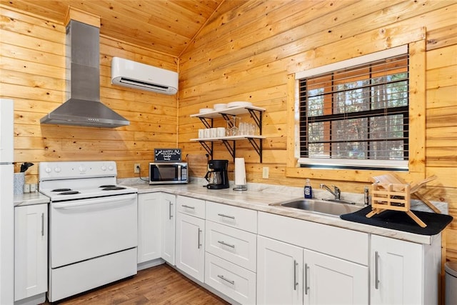 kitchen featuring sink, white cabinetry, a wall mounted air conditioner, electric range, and wall chimney range hood