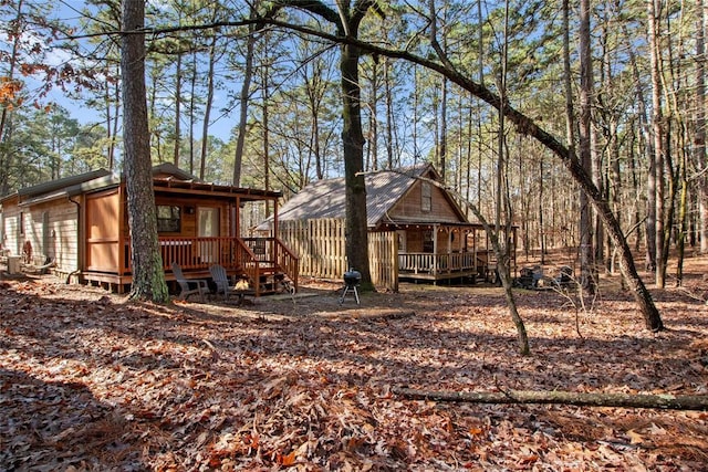 rear view of house featuring covered porch