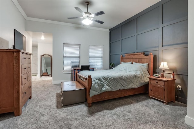 bedroom with ceiling fan, ornamental molding, and carpet