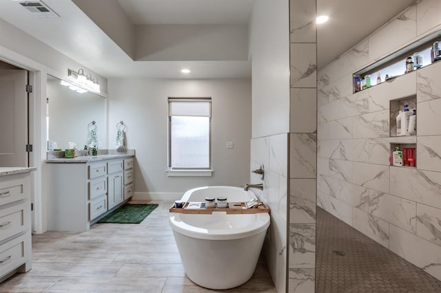 bathroom featuring vanity, shower with separate bathtub, and a wealth of natural light