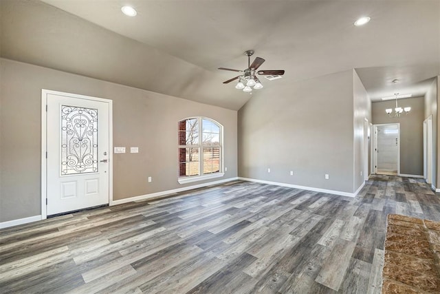 entryway featuring ceiling fan with notable chandelier, wood-type flooring, and vaulted ceiling