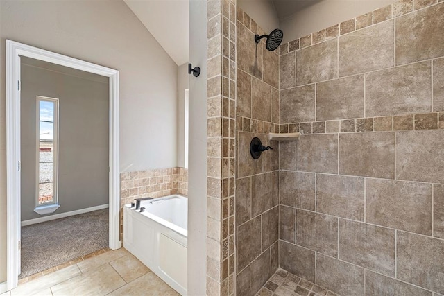 bathroom featuring plus walk in shower, vaulted ceiling, and tile patterned floors