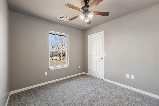 carpeted spare room featuring ceiling fan