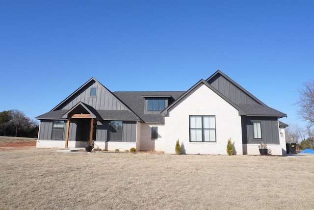 modern farmhouse style home with a front lawn