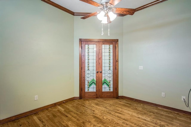 foyer with crown molding, hardwood / wood-style floors, ceiling fan, and french doors