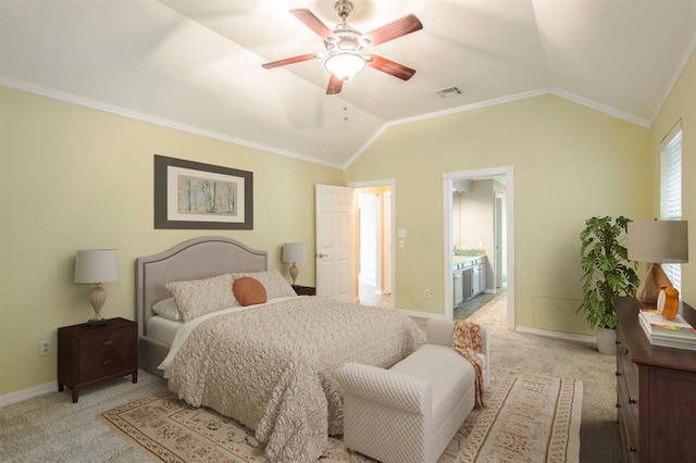 carpeted bedroom with lofted ceiling, ensuite bath, ornamental molding, and ceiling fan