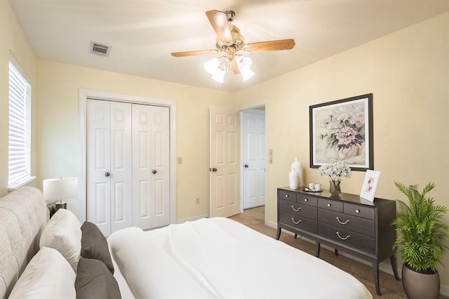 carpeted bedroom featuring ceiling fan and a closet