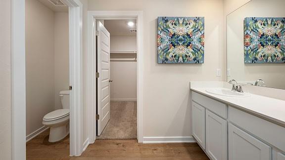 10225 NW 28th St, Yukon, OK 73099 - bathroom featuring wood-type flooring, vanity, and toilet