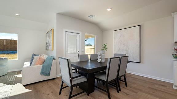 10225 NW 28th St, Yukon, OK 73099 - dining space with dark hardwood / wood-style floors and vaulted ceiling