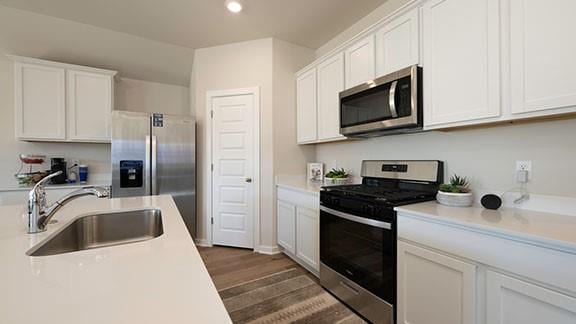 10225 NW 28th St, Yukon, OK 73099 - kitchen featuring stainless steel appliances, sink, white cabinets, and dark hardwood / wood-style flooring