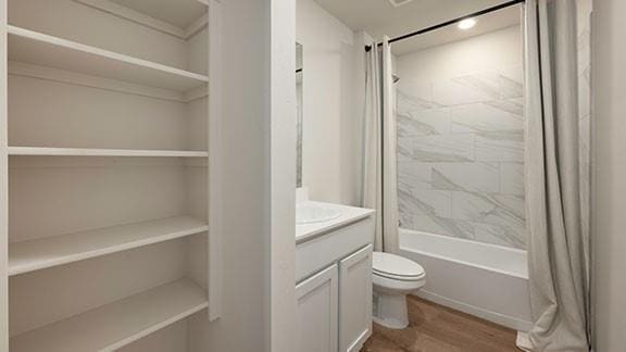 10225 NW 28th St, Yukon, OK 73099 - full bathroom featuring vanity, toilet, wood-type flooring, and shower / bath combo