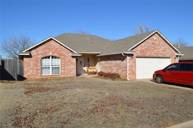 ranch-style home with a garage and a front yard