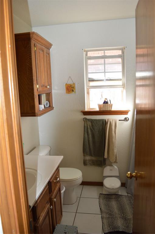 bathroom with tile patterned floors, vanity, and toilet