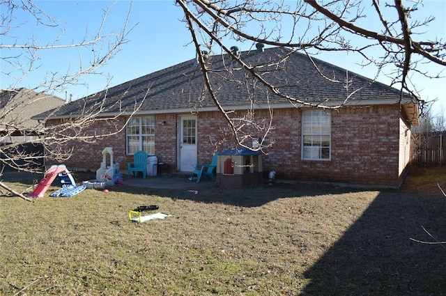 rear view of house with a yard and a patio area