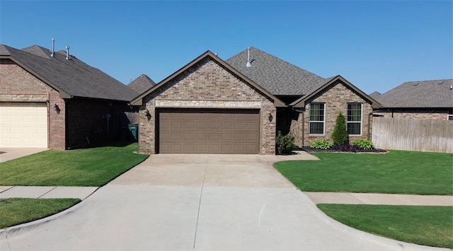 view of front of property featuring a garage and a front lawn