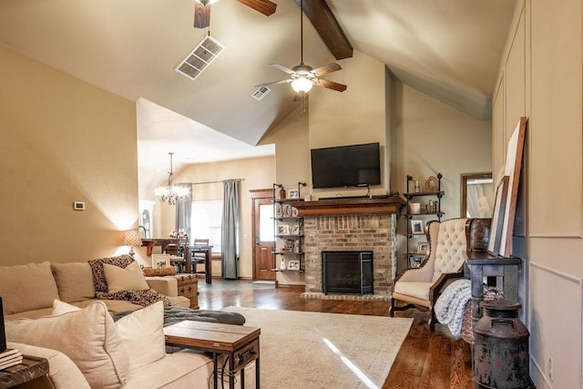 living room with beam ceiling, high vaulted ceiling, hardwood / wood-style floors, a fireplace, and ceiling fan with notable chandelier