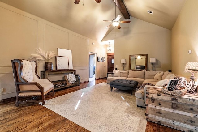 living room featuring beam ceiling, high vaulted ceiling, ceiling fan, and hardwood / wood-style flooring