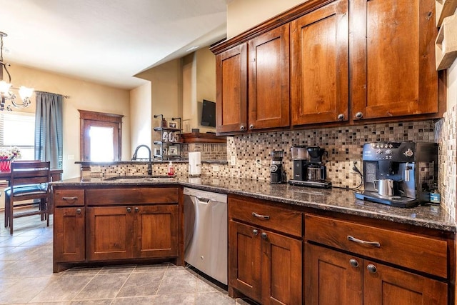 kitchen with pendant lighting, sink, dark stone countertops, tasteful backsplash, and stainless steel dishwasher