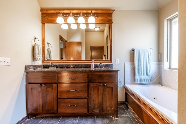 bathroom featuring a tub to relax in, a healthy amount of sunlight, tile patterned flooring, and vanity