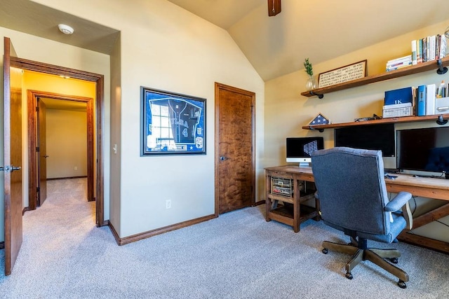 carpeted office featuring lofted ceiling