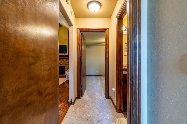 hallway featuring light colored carpet