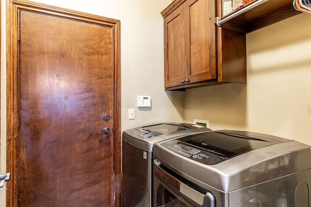 laundry room with cabinets and washing machine and dryer