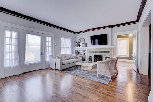 living room with crown molding and hardwood / wood-style floors