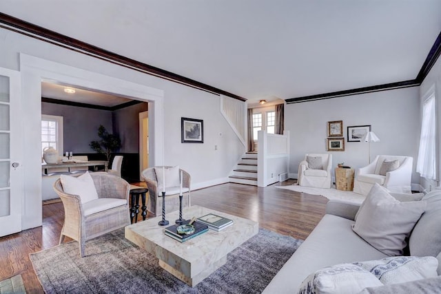 living room featuring ornamental molding, dark hardwood / wood-style floors, and a healthy amount of sunlight