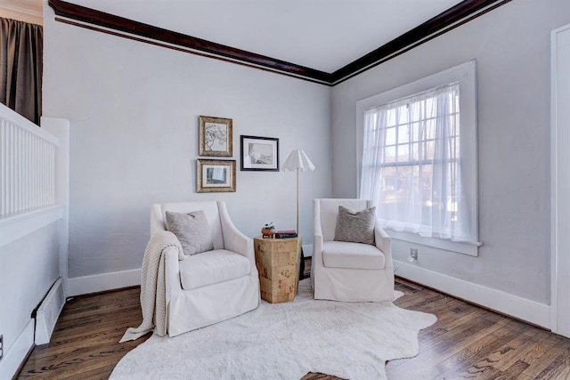 living area featuring crown molding and dark wood-type flooring