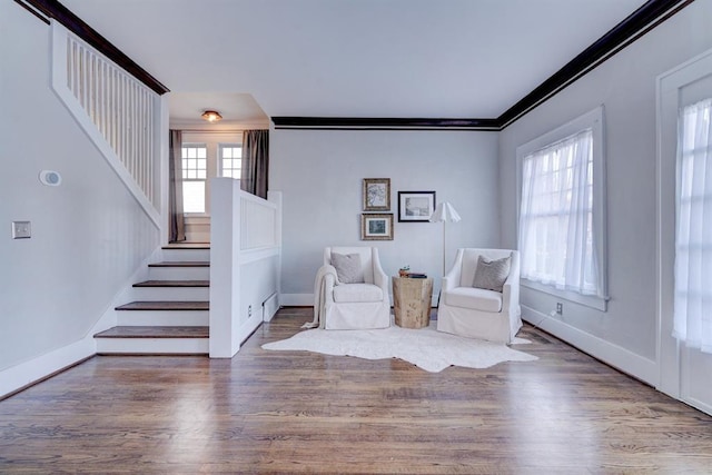 unfurnished room with crown molding, baseboard heating, and hardwood / wood-style flooring