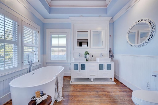 bathroom featuring crown molding, vanity, a bathtub, and hardwood / wood-style flooring