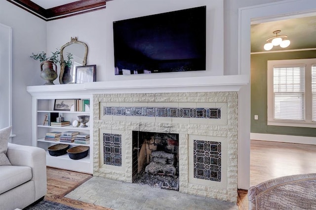 208 NW 20th St, Oklahoma City, OK 73103 - living area featuring crown molding, wood finished floors, and a fireplace with flush hearth