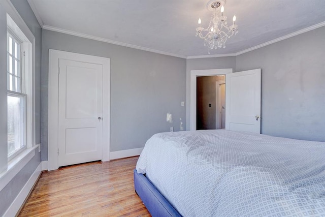 208 NW 20th St, Oklahoma City, OK 73103 - bedroom with light wood-style floors, crown molding, an inviting chandelier, and baseboards