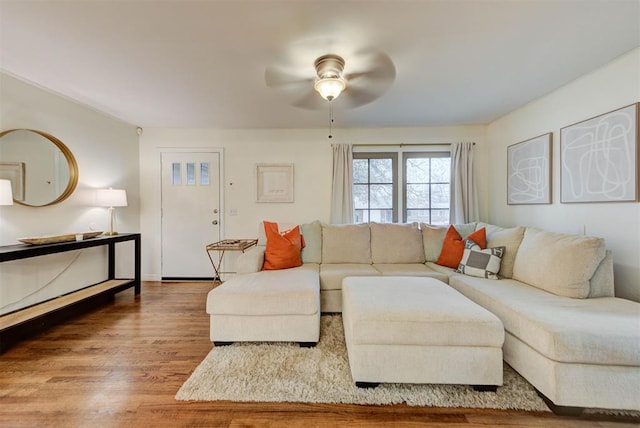 living room with a ceiling fan and wood finished floors