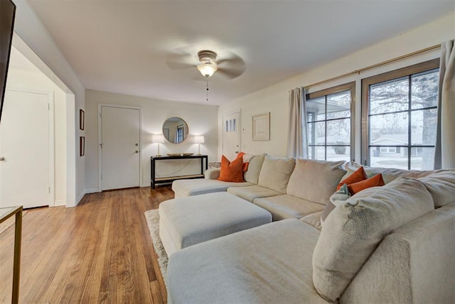 living room with wood finished floors and ceiling fan