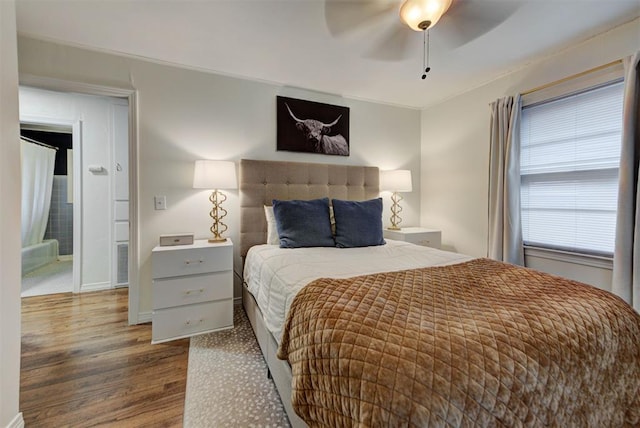 bedroom featuring ceiling fan, baseboards, dark wood-style floors, and ornamental molding