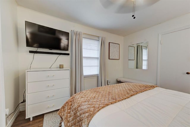 bedroom with dark wood-type flooring and a ceiling fan