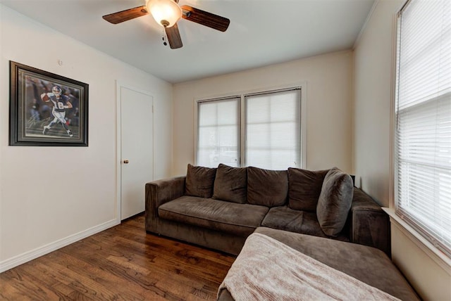 living area with ceiling fan, baseboards, and dark wood finished floors