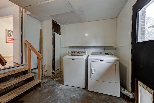 washroom with independent washer and dryer and laundry area