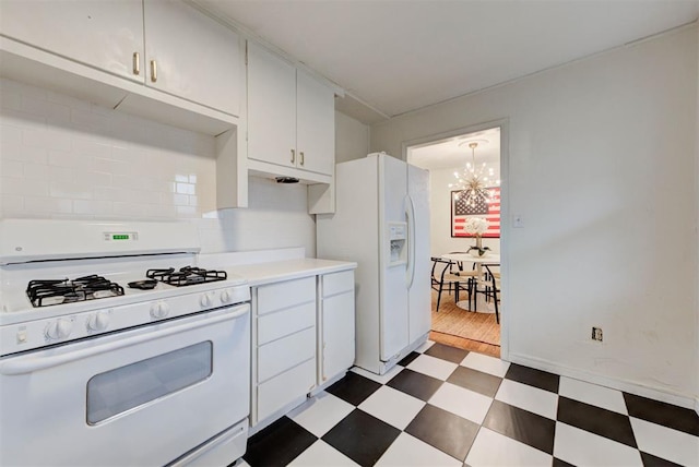 kitchen with white cabinetry, white appliances, dark floors, light countertops, and a chandelier