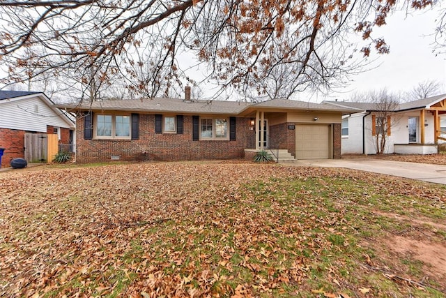 ranch-style home featuring concrete driveway, brick siding, a garage, and a chimney