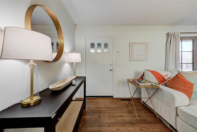 entrance foyer with baseboards and wood finished floors