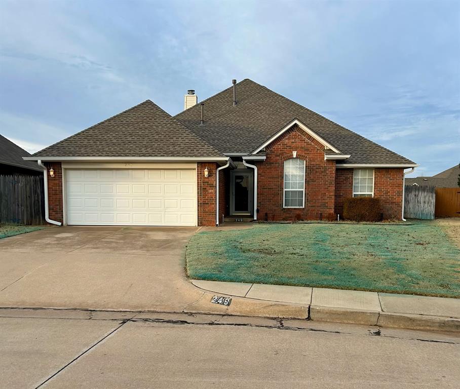 view of front of property with a garage and a front lawn