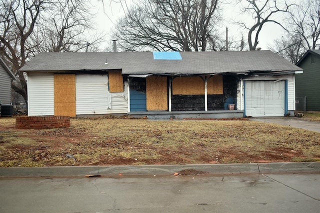 view of front of home with central AC and a garage