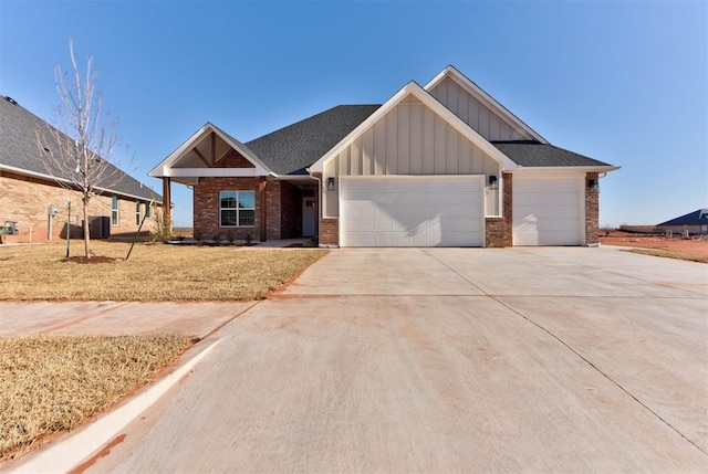 view of front of house with brick siding, board and batten siding, concrete driveway, and a garage