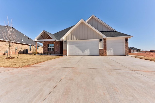 view of front of home featuring brick siding, board and batten siding, concrete driveway, cooling unit, and a garage